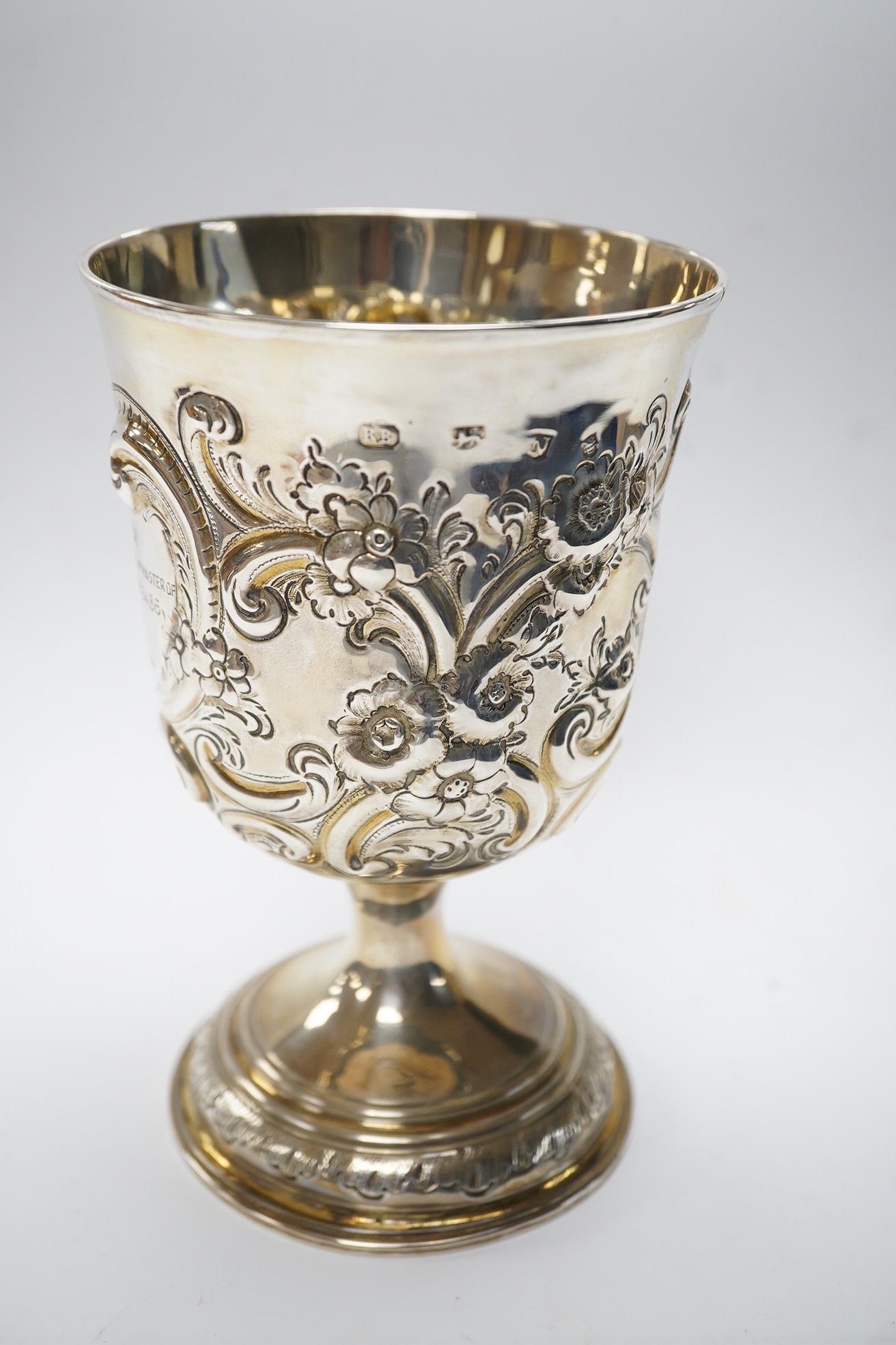 A George II silver goblet, with later embossed decoration and inscription, maker RB London, 1728, 16.6cm, 8.9oz. Condition - fair